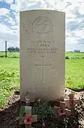 A headstone made of white Portland stone with the Middlesex Regiment cap badge on top in John Parr's name, age and date of death below