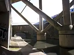 The aqueduct behind struts of motorway looking towards Birmingham