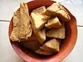 Tahu goreng (fried tofu) has brown skin.