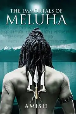 Back profile of Shiva overlooking a huge lake, which is surrounded by snow-clad mountains. In front of his naked torso, a trident is kept