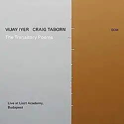 On a sheet, two rectangles uneven in size sit vertically touching each other; one metallic silver on the left, and one bronze on the right. Small indentations are visible between the rectangles. The album name, artists and venue's names are printed on the silver rectangle, and the record label wordmark is printed on the bronze rectangle.