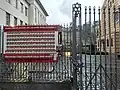 A sign with pictures of the hostages in Gaza, on the synagogue gates