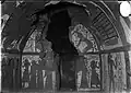 South wall from the burial chamber of the tomb. The wall is quite damaged. Identifiable in the upper register is the goddess Nephthys kneeling and on the other side is the goddess Isis, also kneeling. Only the feet of the goddess Isis remain. In the lower register there are adoration scenes.