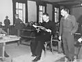 Polish priest Theodore Korcz (left) reads from the Malaria protocols on 22&nbsp;November 1945