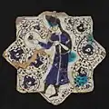 Tile with standing man holding a pomegranate. Late 1220s
