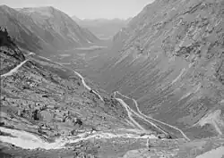 The deep U-shaped Isterdalen&nbsp;[no] valley in Norway ends abruptly giving rise to tall waterfalls. Trollstigen road climbs the steep cliffs of the trough end.