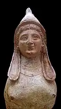 Sphinx with prominent breasts.