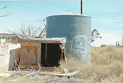 Tank behind the abandoned Twin Arrows Trading Post