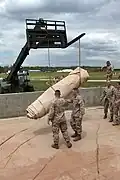 Transport of a folded collapsible tank