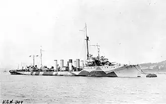 USS Cassin (DD-43) moored alongside another U.S. Navy destroyer, at Queenstown, Ireland, circa 1918. She is painted in "Dazzle" type camouflage.