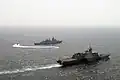 A rigid-hull inflatable boat from the LCS USS&nbsp;Freedom takes a visit, board, search and seizure team to the Malaysian frigate KD Jebat during a compliant boarding exercise.