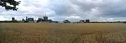 Elementis factory behind corn fields.