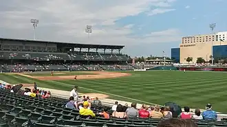 A green baseball field surrounded by a seating bowl