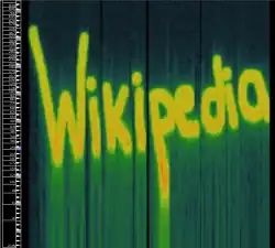 The word "Wikipedia" in yellow over a dark blue/black background