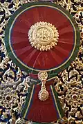 A woodcarving of "Maha Varabhorn", the Knight Grand Cross (First Class) of the Order of the White Elephant, version that was used from 1869 to 1909, at the gates of Phra Vihara of Wat Ratchabophit Sathit Maha Simaram, Bangkok.