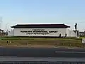 The Yogyakarta International Airport's nameplate with a cungkup above it