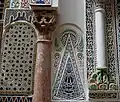 Marble column (left) embedded in the outer south wall of the mausoleum, believed to be a spolia from the Almoravid period